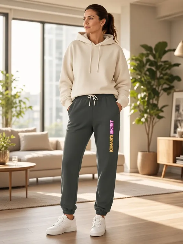 Model wearing the Kumasi's Secret charcoal jogger sweatpants with vertical lettering, view 2